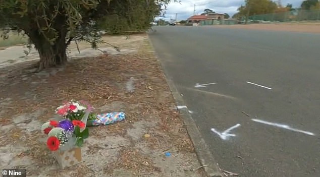 Flowers lay at the scene where a boy fell off his bike and died in Collie on Sunday afternoon