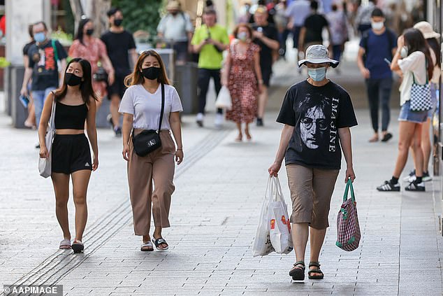 Nearly 250,000 Australians have tested positive for Covid in the past week, with states including NSW, Victoria, Queensland and Western Australia, recording more than 8,000 cases in the past 24 hours (pictured, members of the public walking in Brisbane wearing masks)